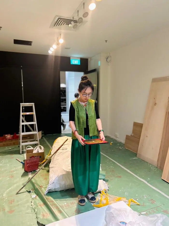 风水师 Master Yixin 在装修中的房屋内使用罗盘进行居家风水布局