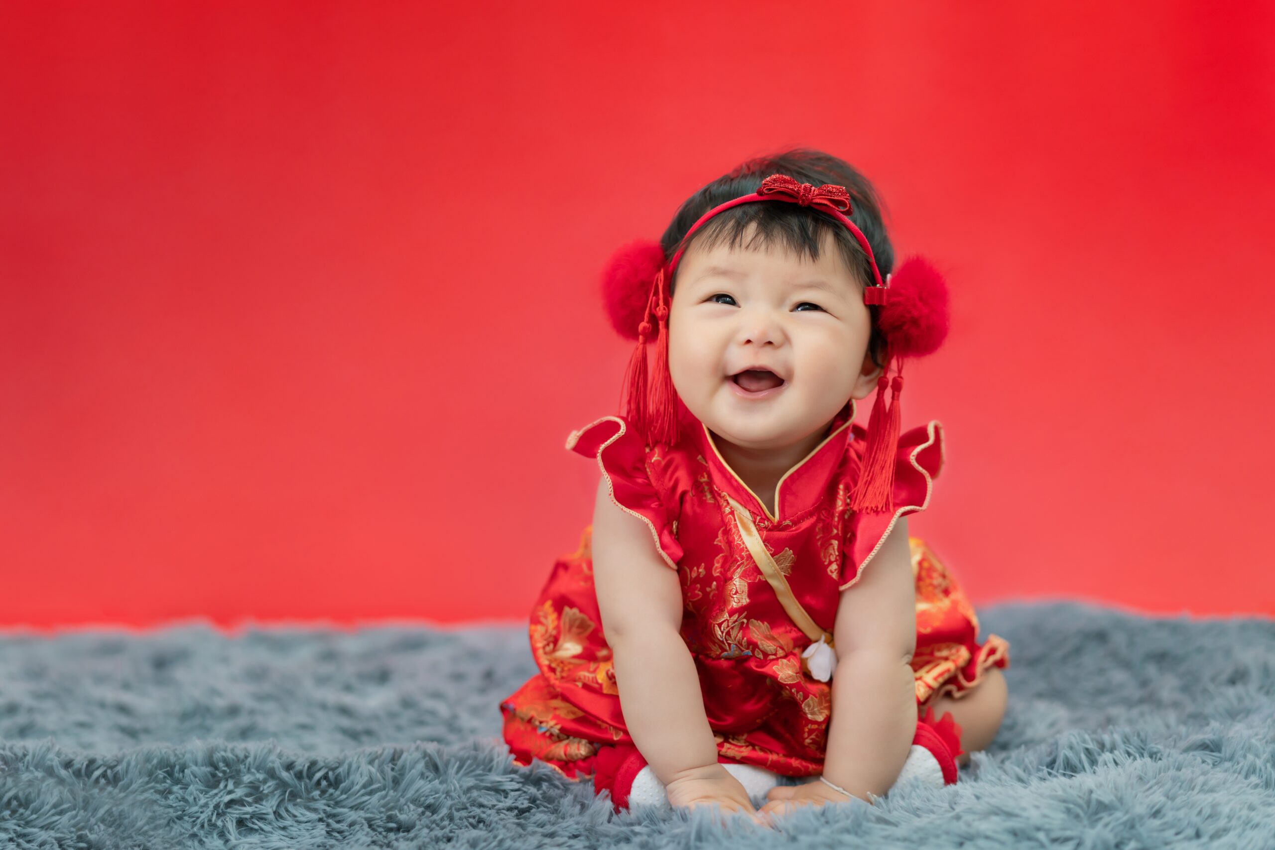 A Chinese Baby Wearing a Traditional Red Chinese Clothing A Chinese Baby Wearing a Traditional Red Chinese Clothing