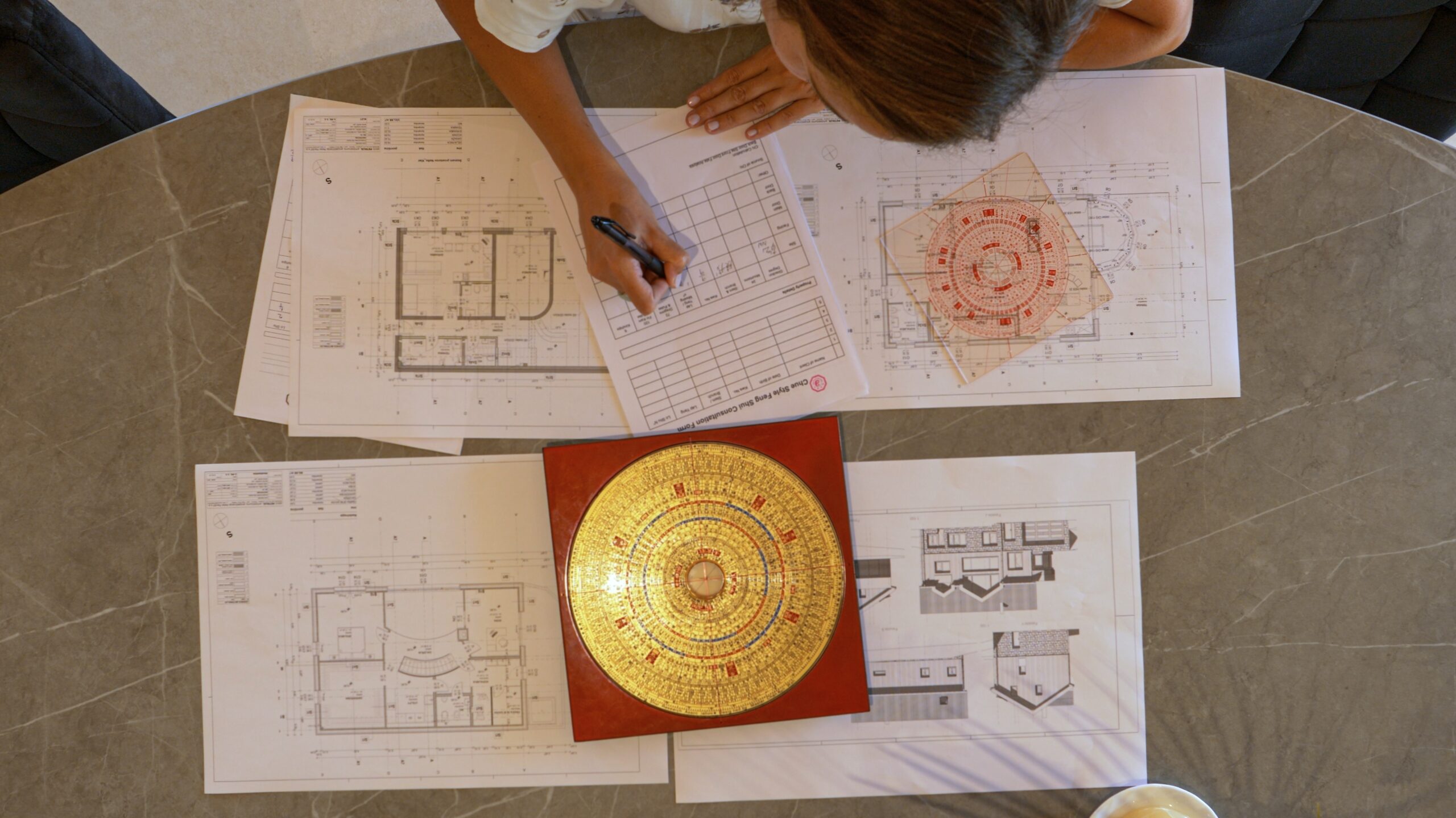 A Top View of a Woman Planning Feng Shui for a House A Top View of a Woman Planning Feng Shui for a House