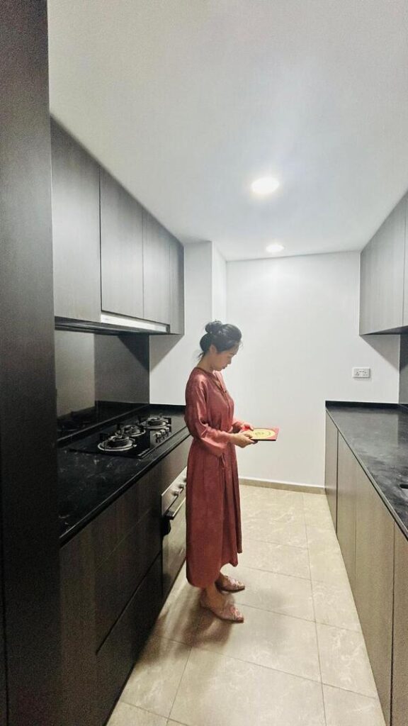 Master Yixin assessing kitchen energy flow during a home consultation, demonstrating how residential Feng Shui services align elements and layout to enhance harmony and prosperity.