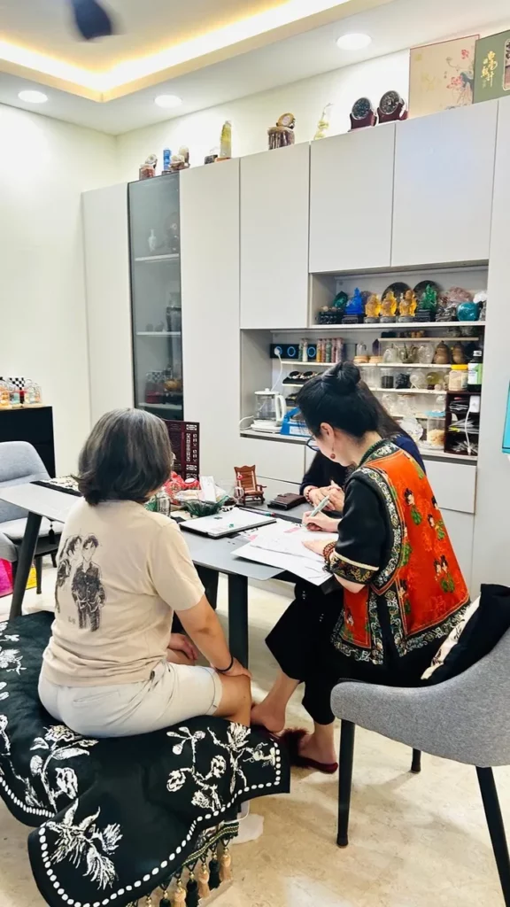 BaZi master conducting a personalised BaZi analysis in Singapore, guiding a client through luck cycles and property investment timing.